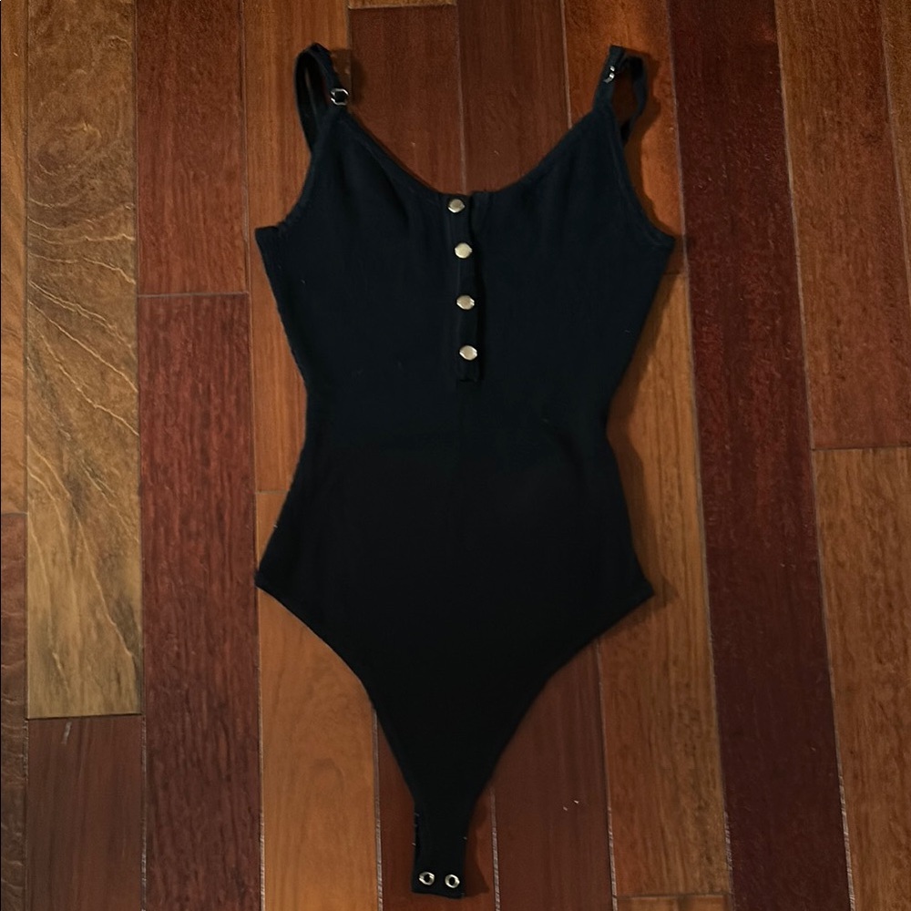 Black bodysuit with gold button accents